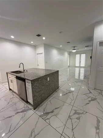 a large room with a large mirror and cabinets