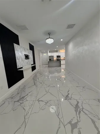 a view of a kitchen with furniture and a ceiling fan