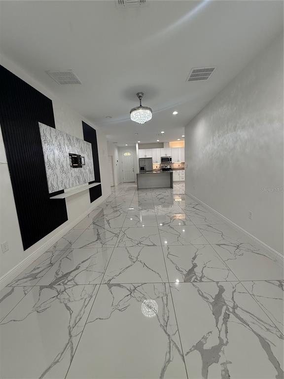 310 Grape Avenue St. Cloud, FL 34769 - Photo 17 of 27 a view of a kitchen with furniture and a ceiling fan
