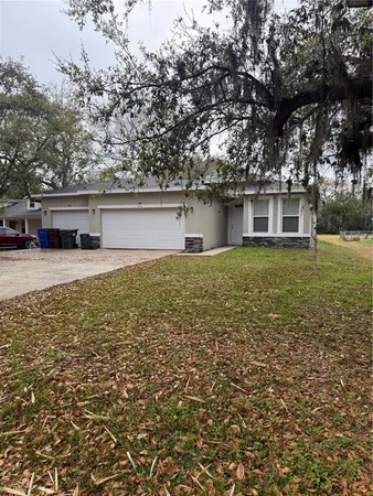front view of a house with yard and trees