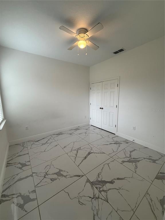 310 Grape Avenue St. Cloud, FL 34769 - Photo 22 of 27 a view of an empty room and chandelier fan