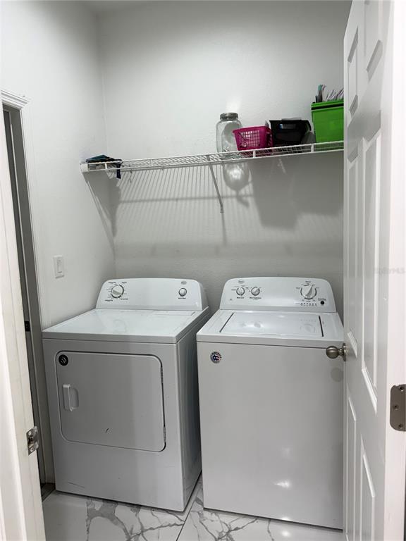 310 Grape Avenue St. Cloud, FL 34769 - Photo 26 of 27 a utility room with dryer and washer