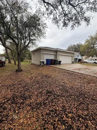 a big house with a big yard and large trees