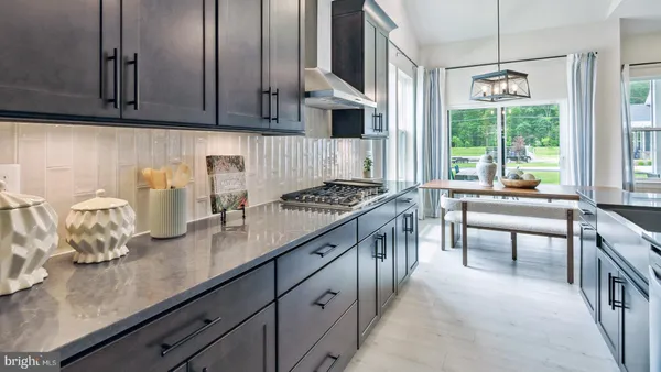 a kitchen with stainless steel appliances granite countertop a sink dishwasher stove and cabinets