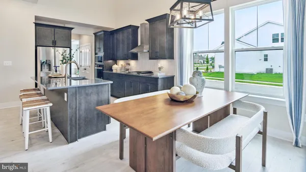 a kitchen with a table chairs and refrigerator