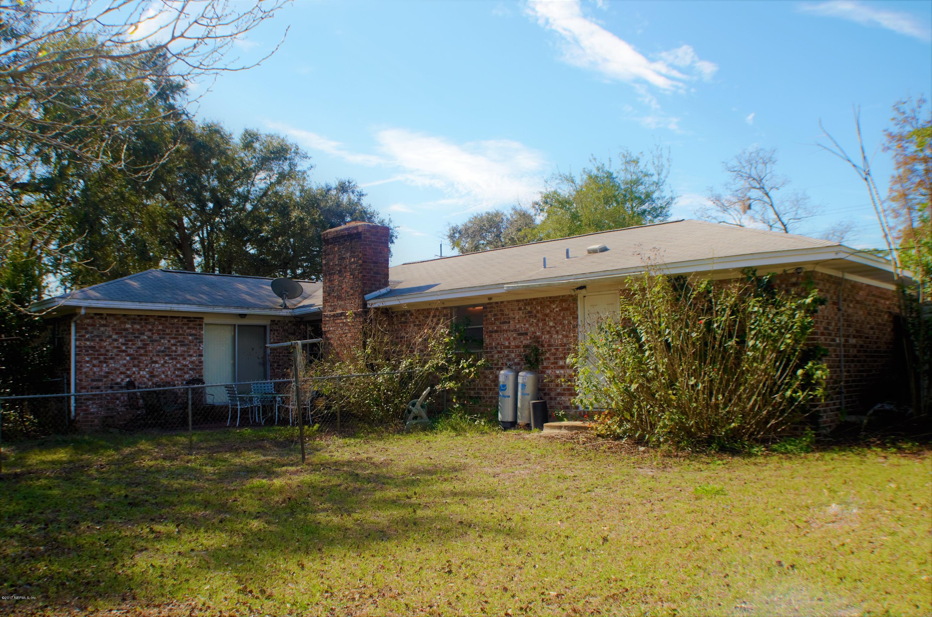 6379 Firestone Road Jacksonville, FL 32244 - Photo 18 of 24 a front view of a house with garden