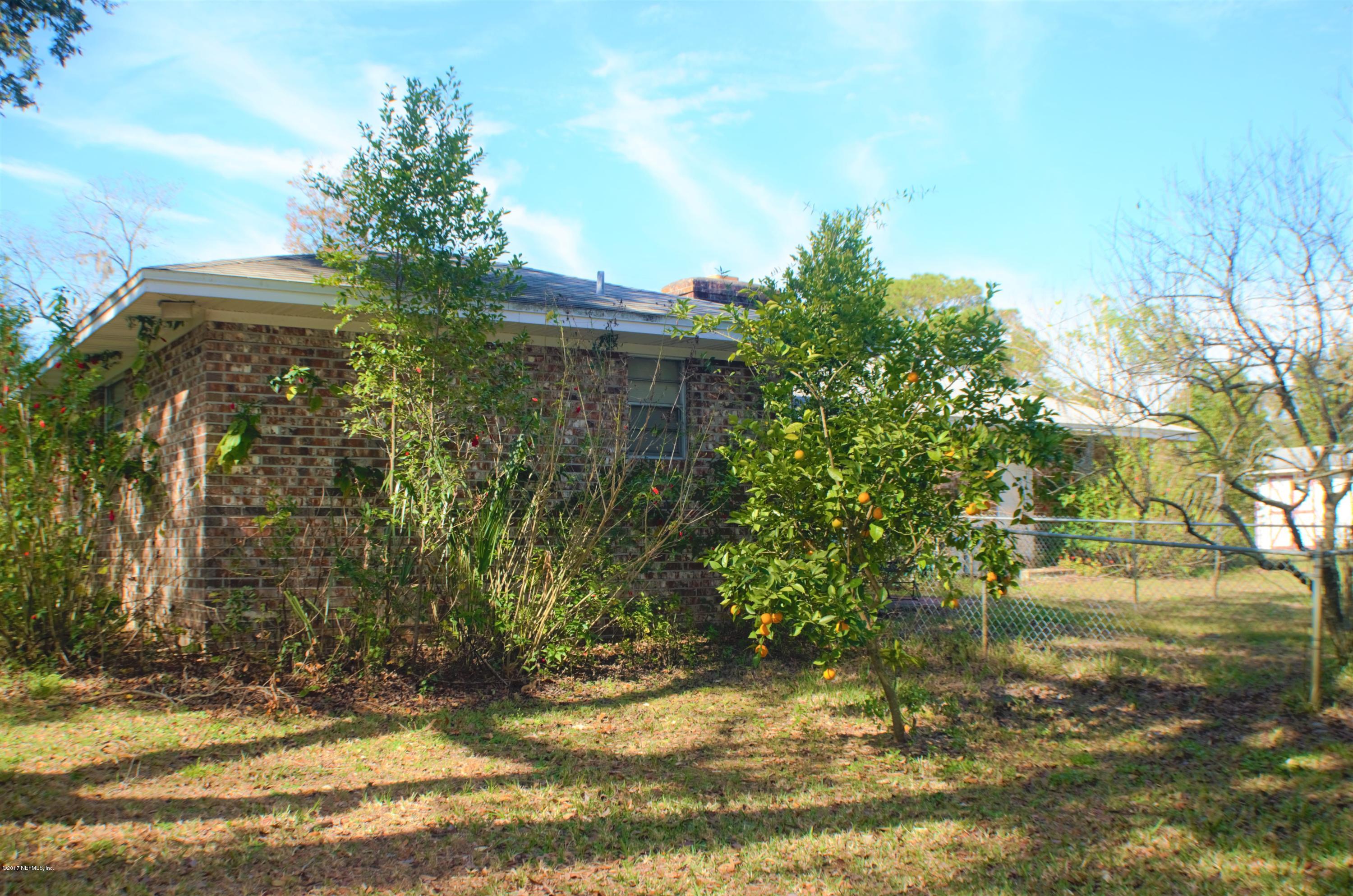 6379 Firestone Road Jacksonville, FL 32244 - Photo 22 of 24 a backyard of a house with lots of green space