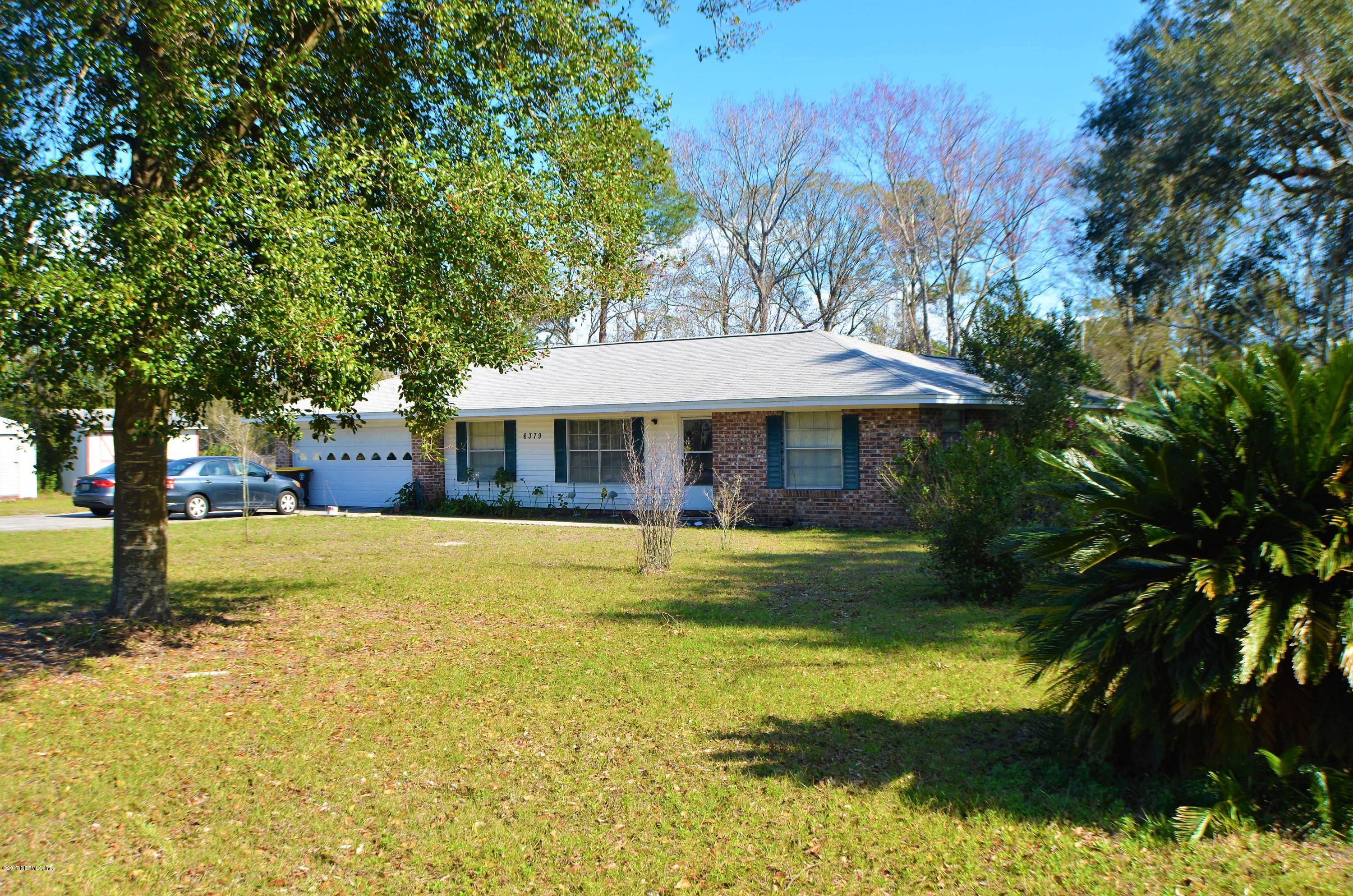 6379 Firestone Road Jacksonville, FL 32244 - Photo 3 of 24 a front view of a house with a yard table and chairs