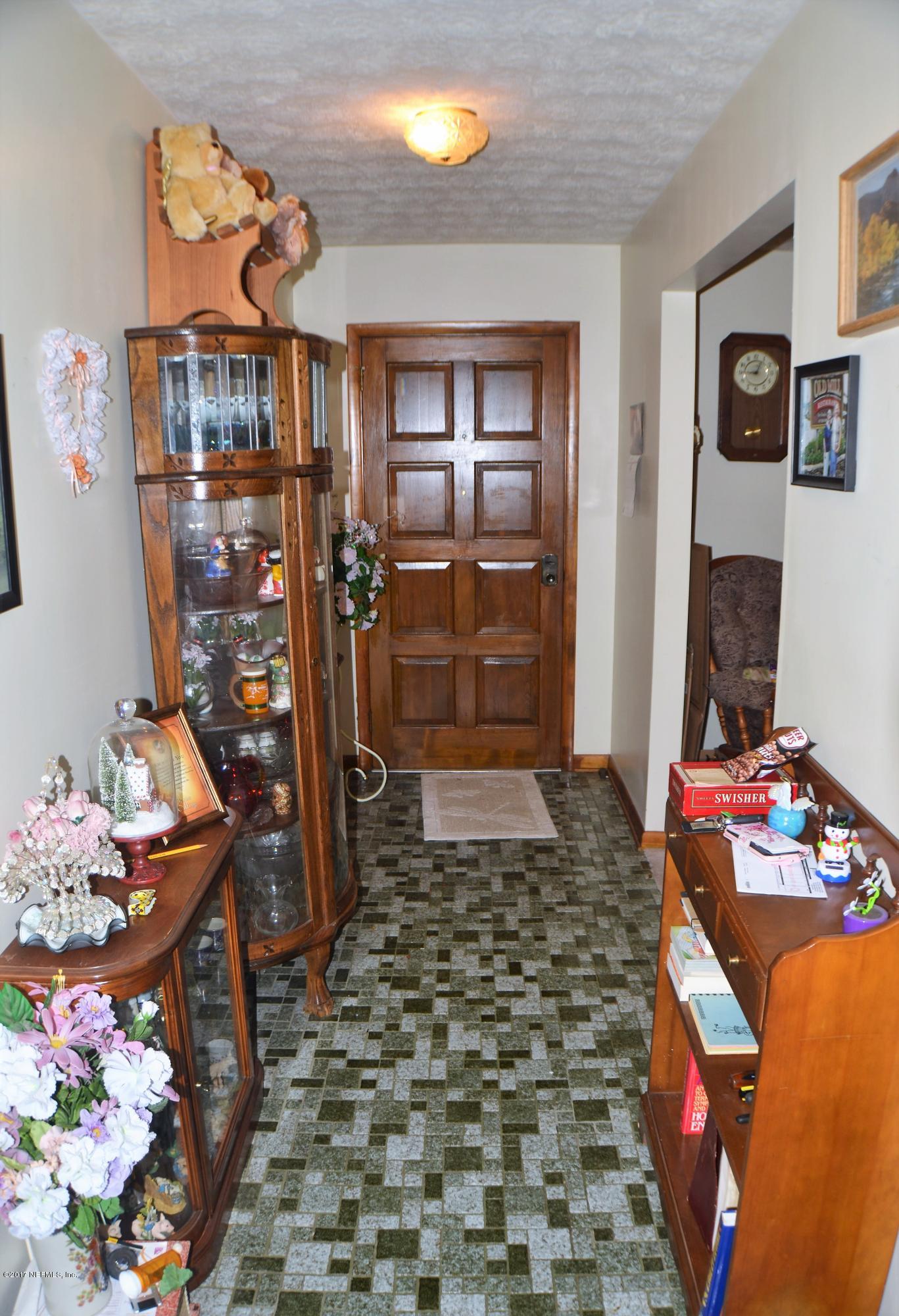 6379 Firestone Road Jacksonville, FL 32244 - Photo 10 of 24 a bedroom with a bed and glass door