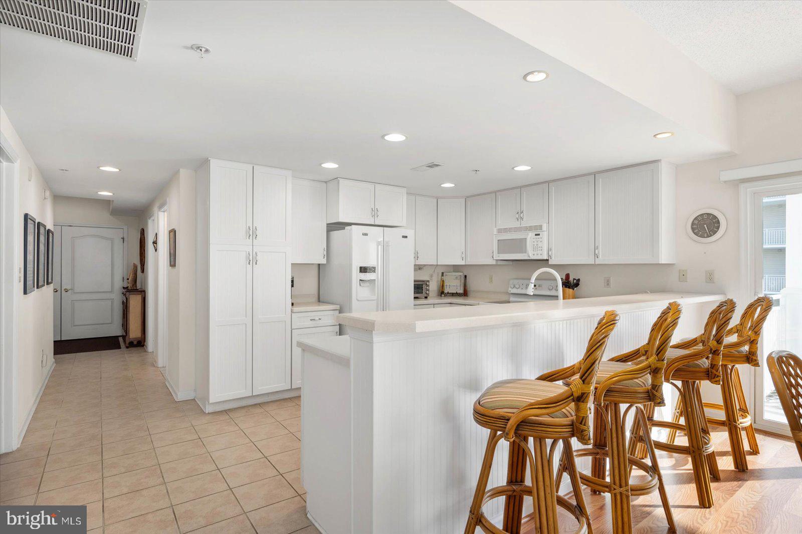 102 Williams Street, Unit 311 Crisfield, MD 21817 - Photo 12 of 57 a kitchen with stainless steel appliances granite countertop a refrigerator and a stove top oven