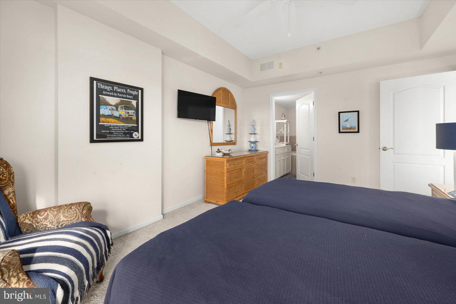 102 Williams Street, Unit 311 Crisfield, MD 21817 - Photo 19 of 57 a bedroom with a bed and a television