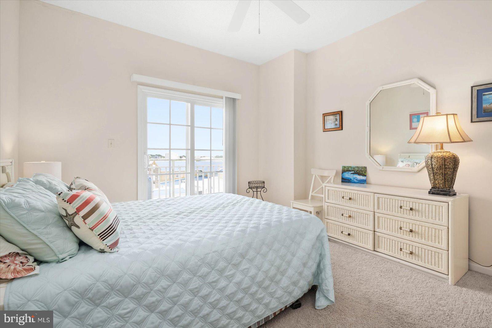 102 Williams Street, Unit 311 Crisfield, MD 21817 - Photo 23 of 57 a bedroom with a bed and window with mirror
