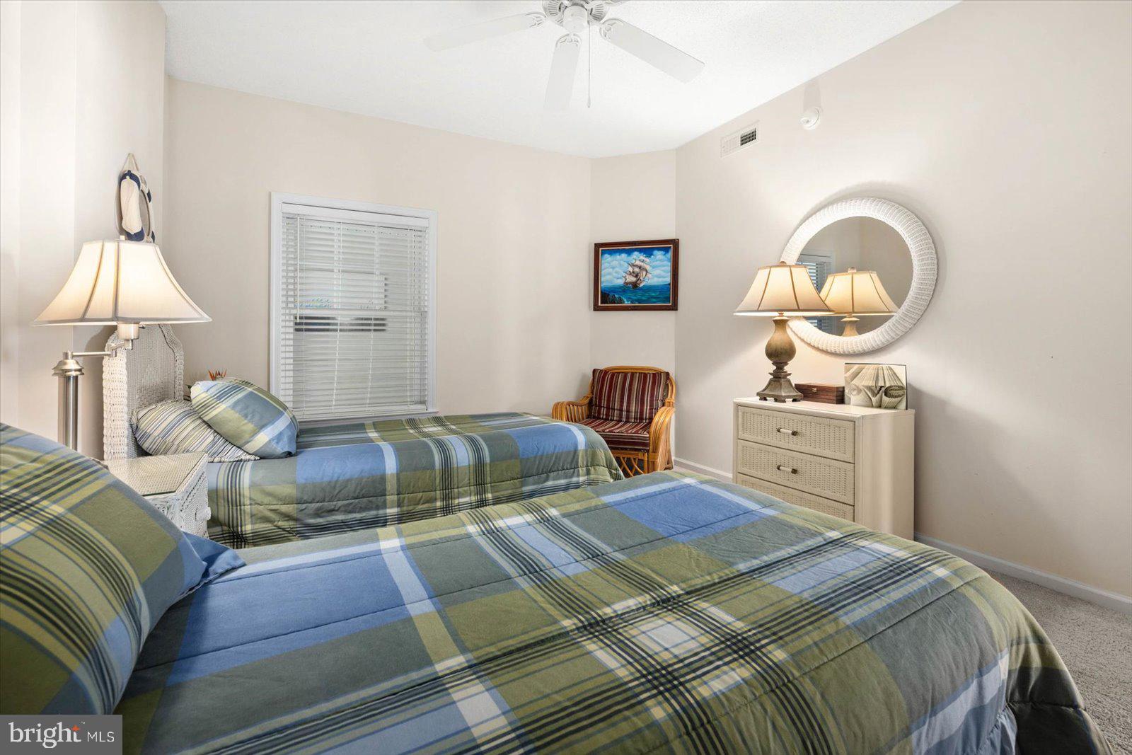 102 Williams Street, Unit 311 Crisfield, MD 21817 - Photo 27 of 57 a bedroom with a bed and a chandelier