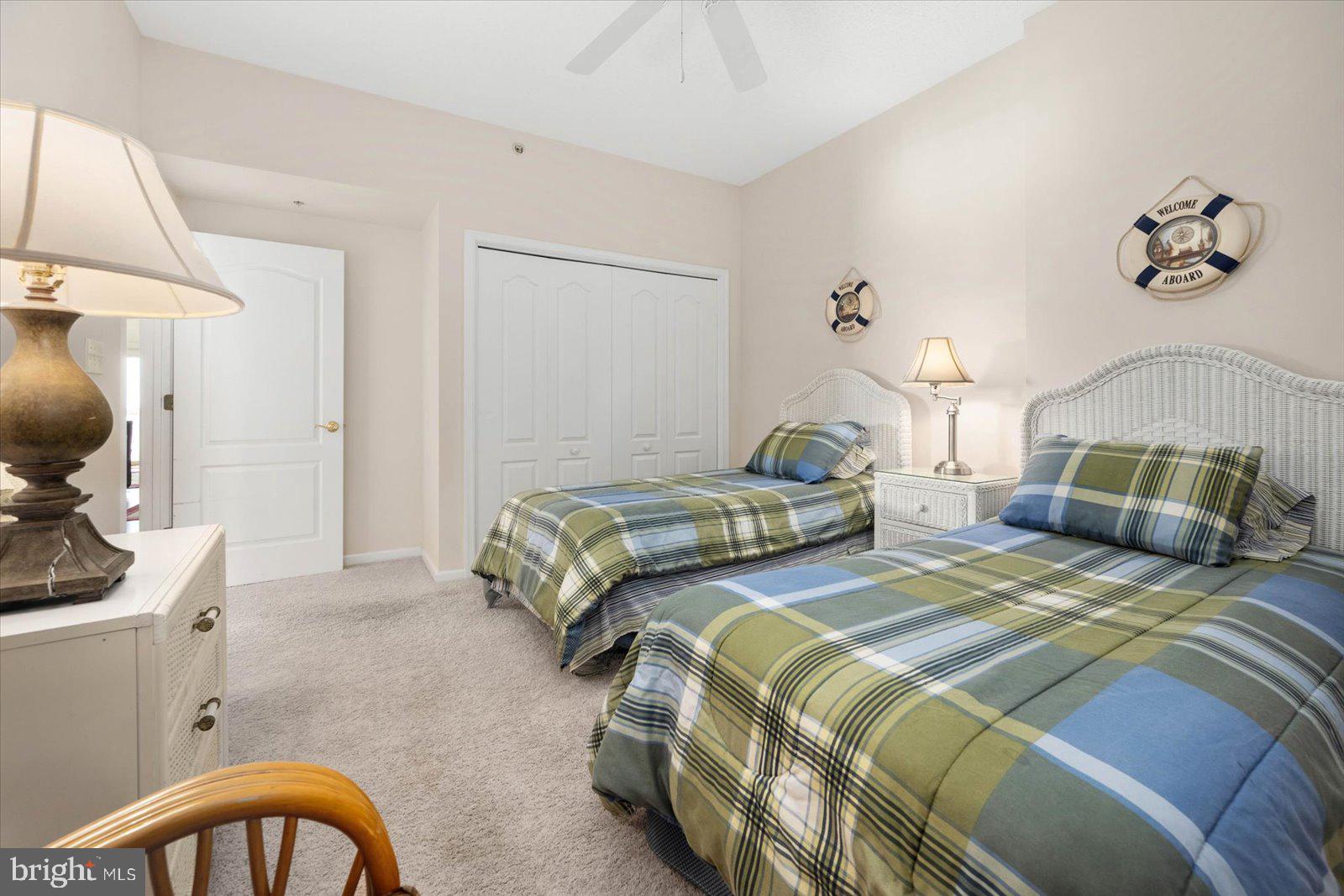 102 Williams Street, Unit 311 Crisfield, MD 21817 - Photo 28 of 57 a bedroom with two beds and a chandelier