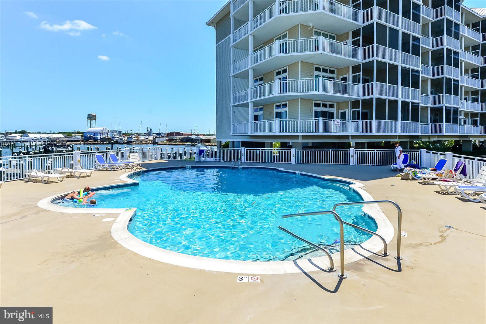 102 Williams Street, Unit 311 Crisfield, MD 21817 - Photo 45 of 57 a view of a swimming pool with outdoor seating