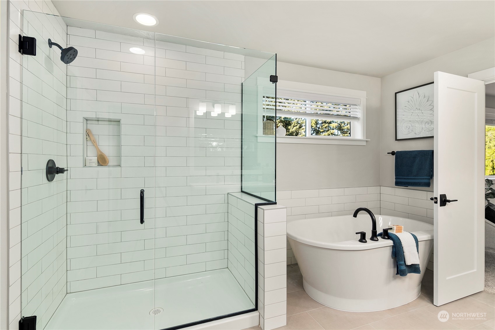 1303 197th Place Southeast Bothell, WA 98012 - Photo 23 of 34 a bathroom with a bathtub and a shower