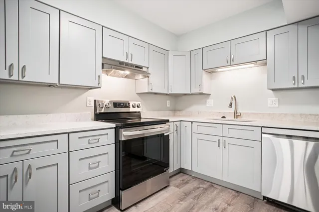 a kitchen with white cabinets and white appliances