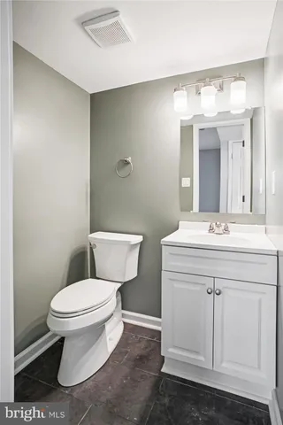 a bathroom with a sink toilet and a mirror