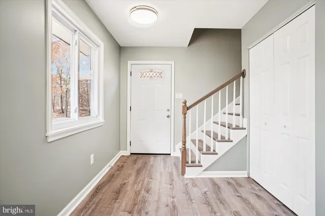 a view of front door with wooden floor