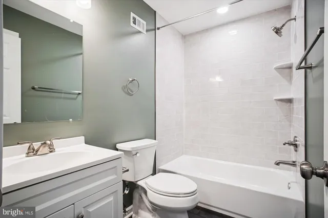 a bathroom with a sink a toilet and a bathtub