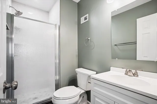 a white toilet sitting next to a bathroom sink