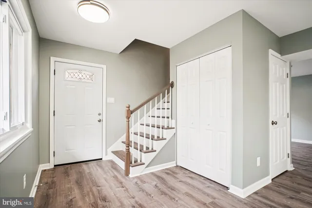 a view of an entryway with wooden floor