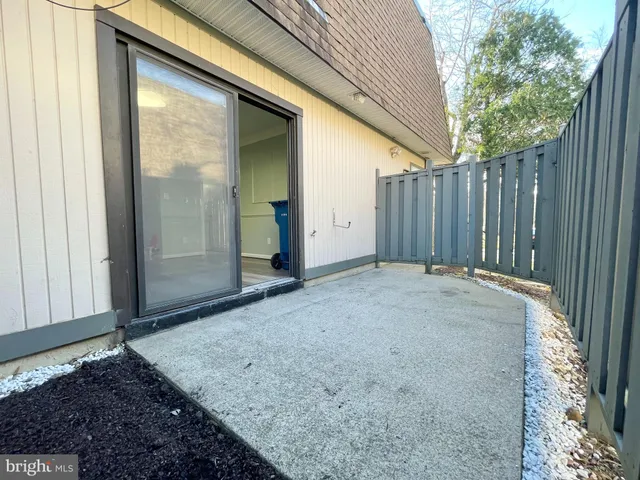 a view of a backyard with wooden fence