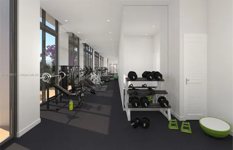 a room with gym equipment and a mirror
