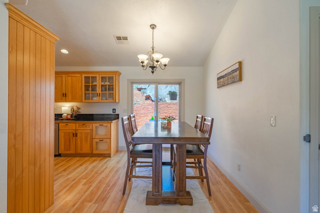1504 Rome Way Apple Valley, UT 84737 - Photo 5 of 22 Open concept dining area featuring wood-finish flooring and a contemporary chandelier