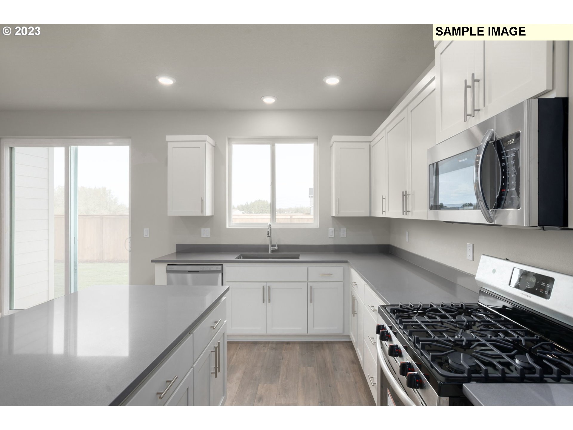 2018 Southeast Teal Avenue Gresham, OR 97080 - Photo 6 of 17 a kitchen with a stove a sink and a refrigerator