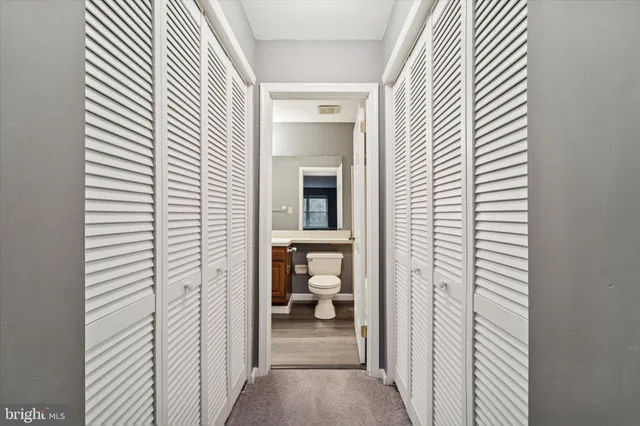 a view of a livingroom and a bathroom with a window