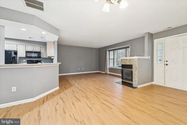a view of kitchen with wooden floor and electronic appliances