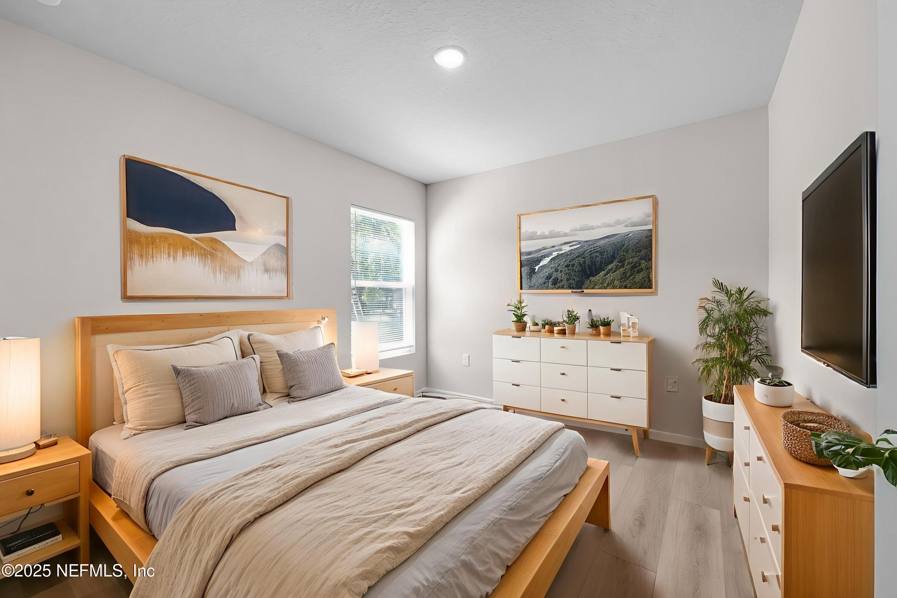 3945 Rose Street Jacksonville, FL 32208 - Photo 18 of 27 a bedroom with a bed and a flat screen tv on dresser