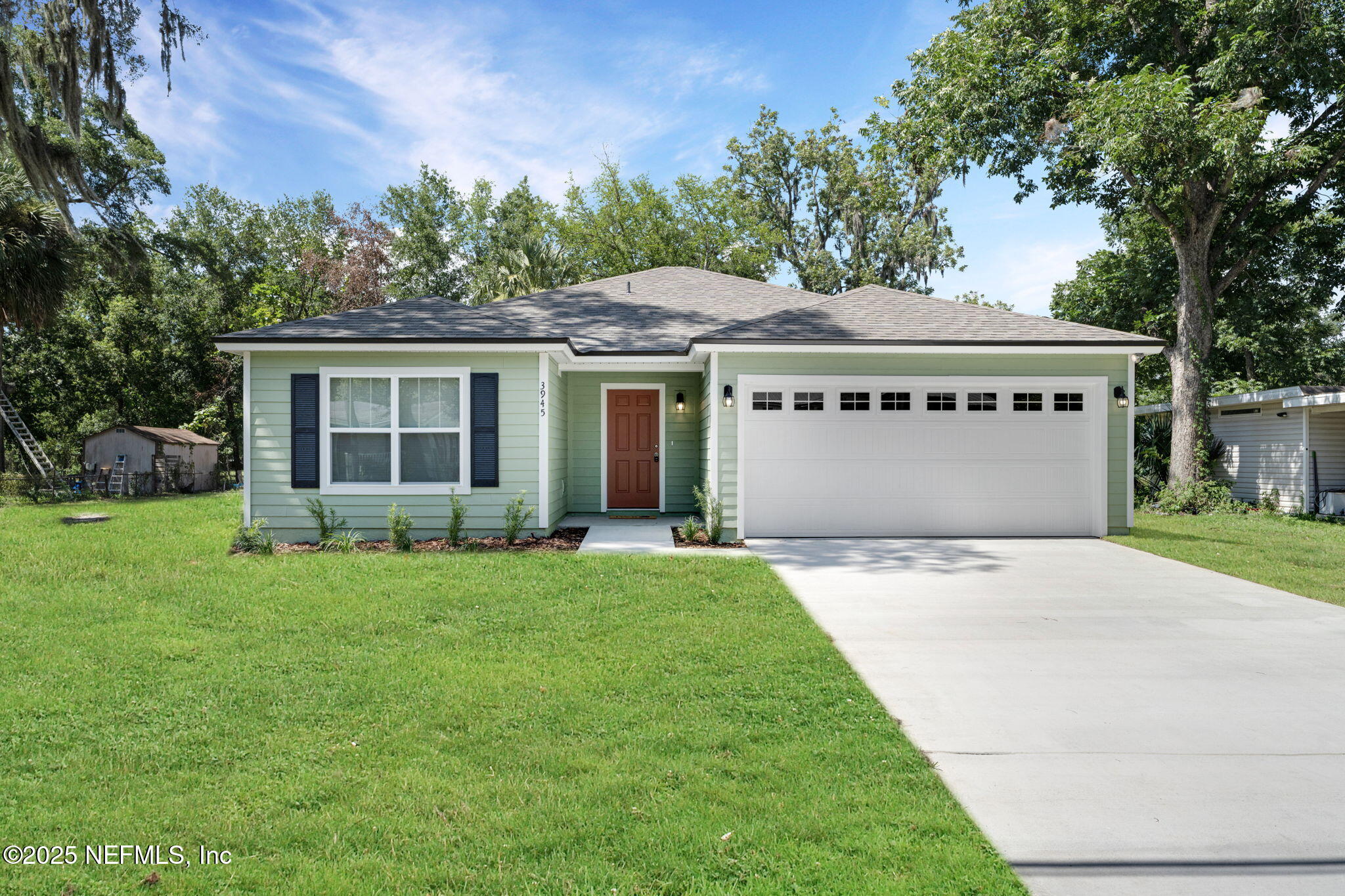 3945 Rose Street Jacksonville, FL 32208 - Photo 2 of 27 a front view of a house with a garden