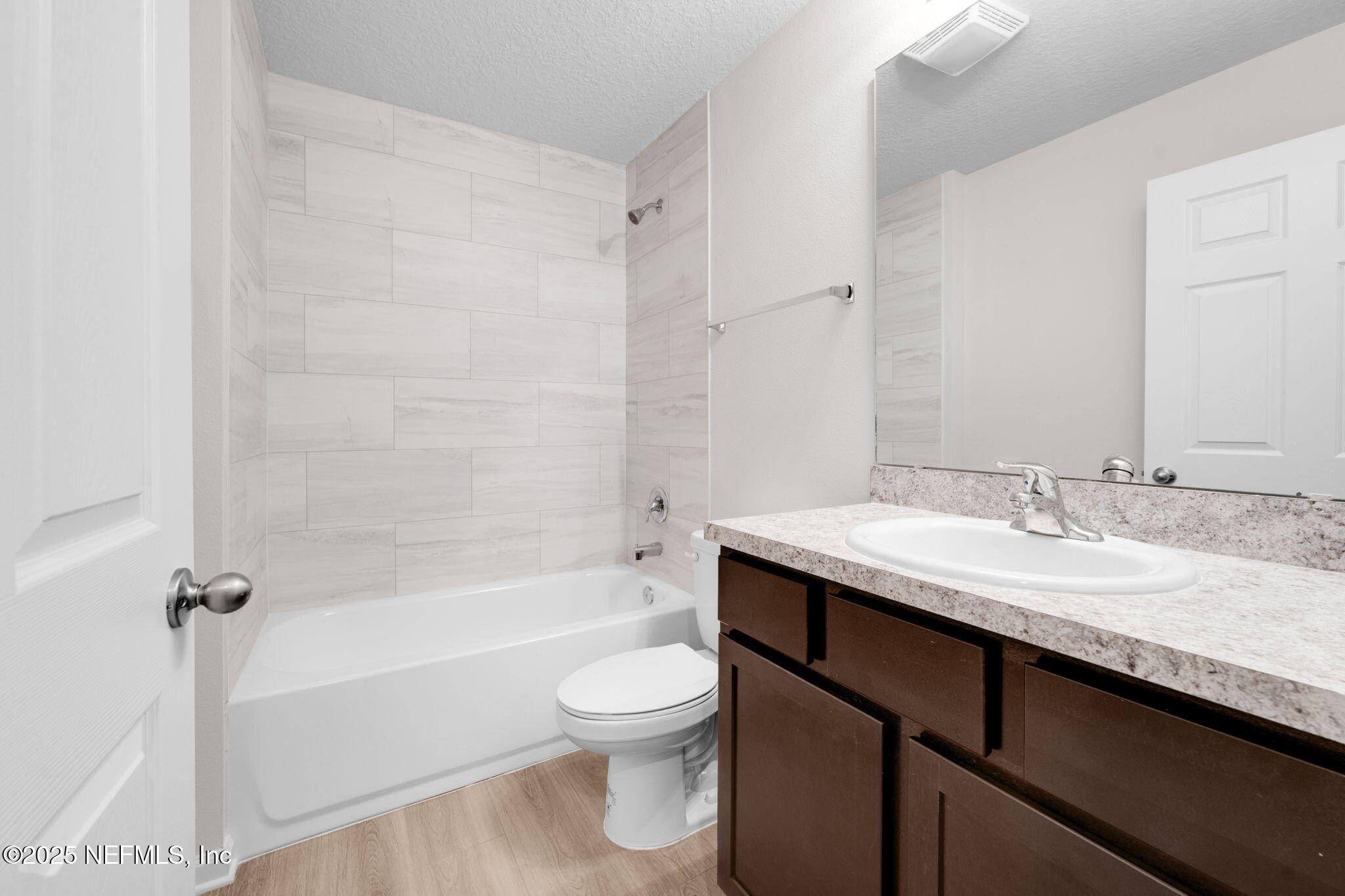 3945 Rose Street Jacksonville, FL 32208 - Photo 21 of 27 a bathroom with a granite countertop sink toilet a mirror and bathtub