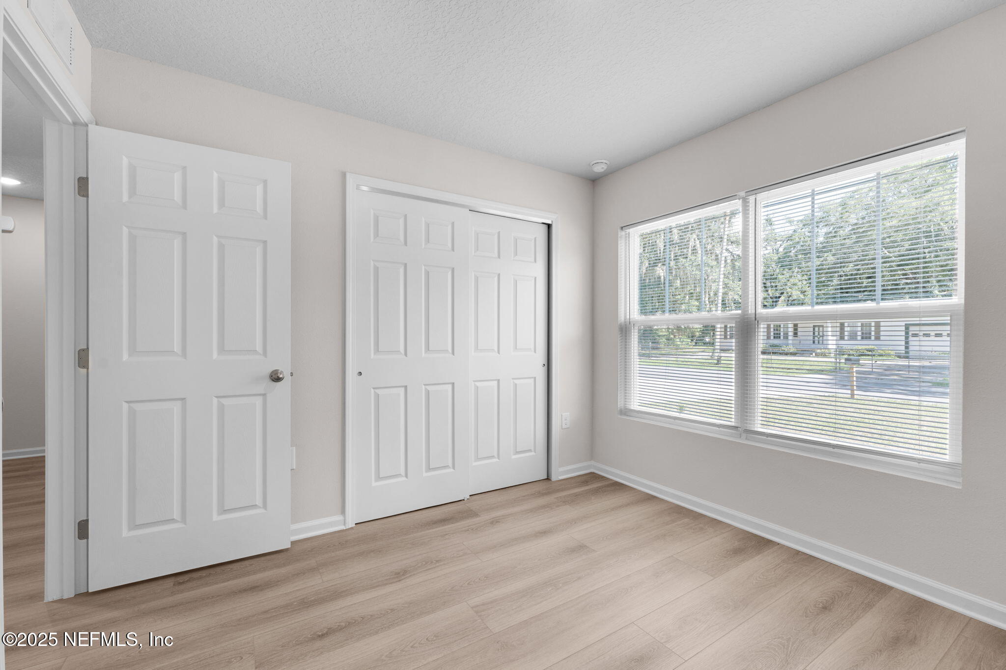 3945 Rose Street Jacksonville, FL 32208 - Photo 24 of 27 a view of an empty room with wooden floor and a window