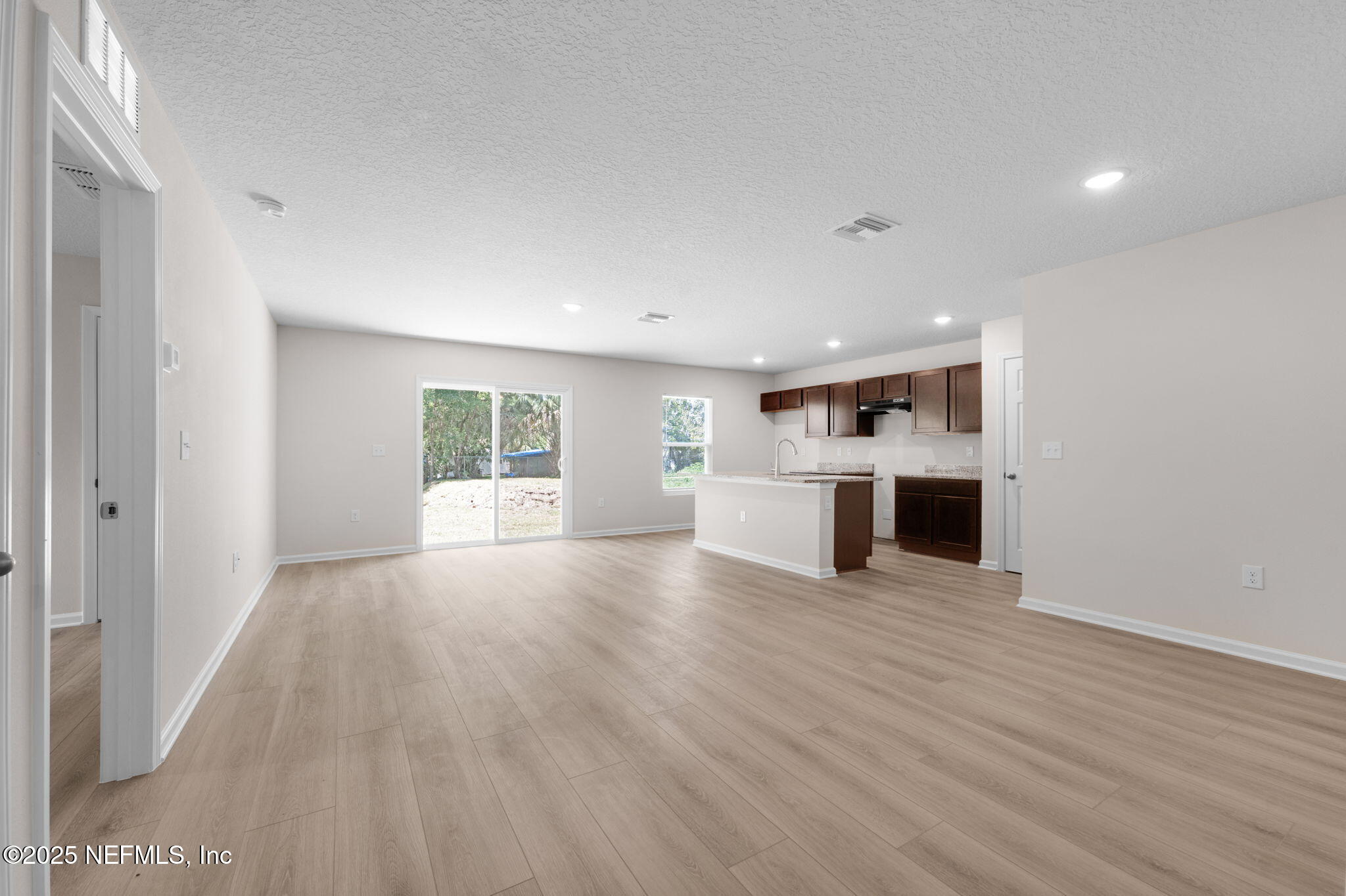 3945 Rose Street Jacksonville, FL 32208 - Photo 5 of 27 a view of a big room with wooden floor and windows