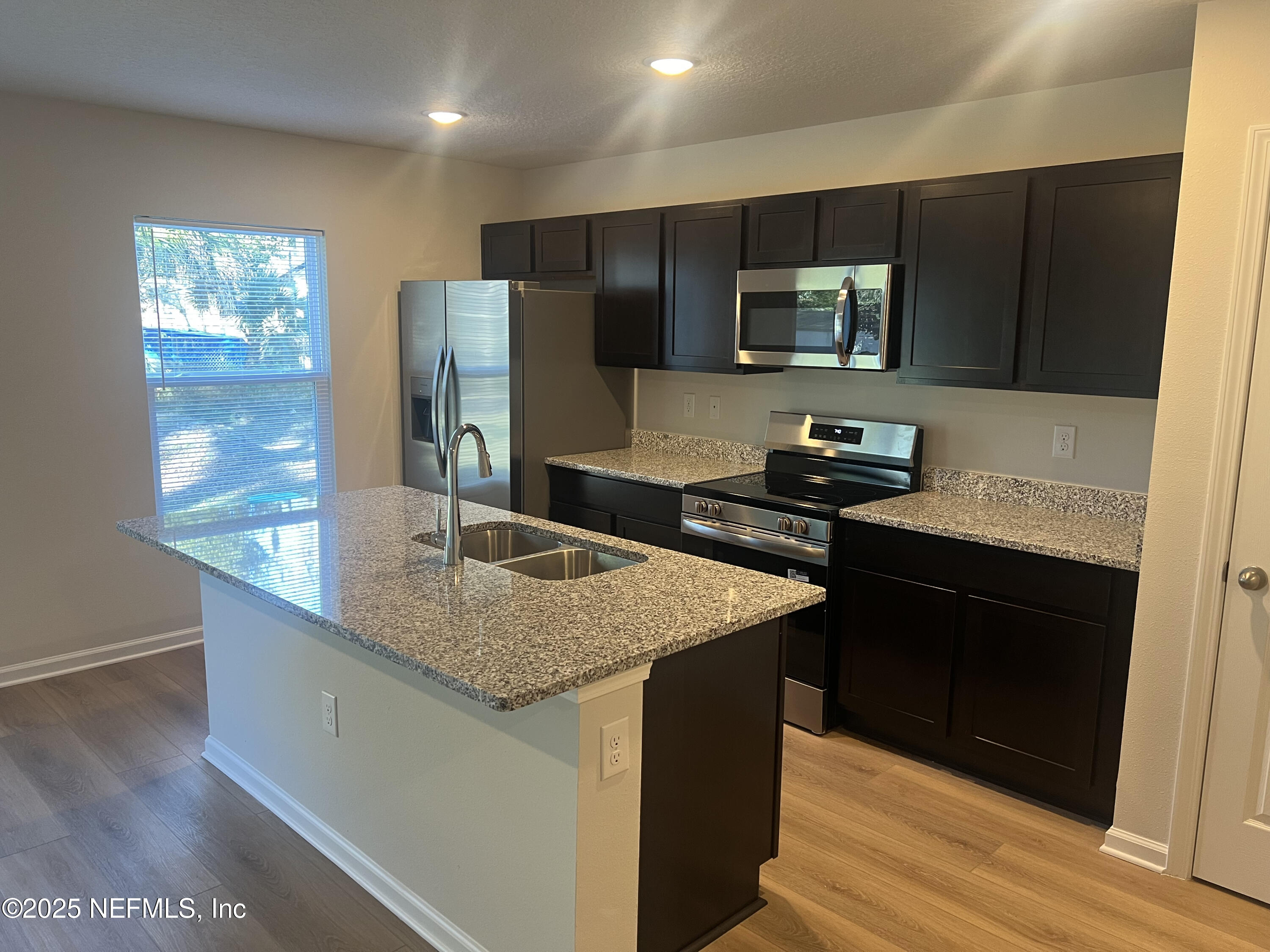 3945 Rose Street Jacksonville, FL 32208 - Photo 8 of 27 a kitchen with stainless steel appliances granite countertop a sink stove and refrigerator