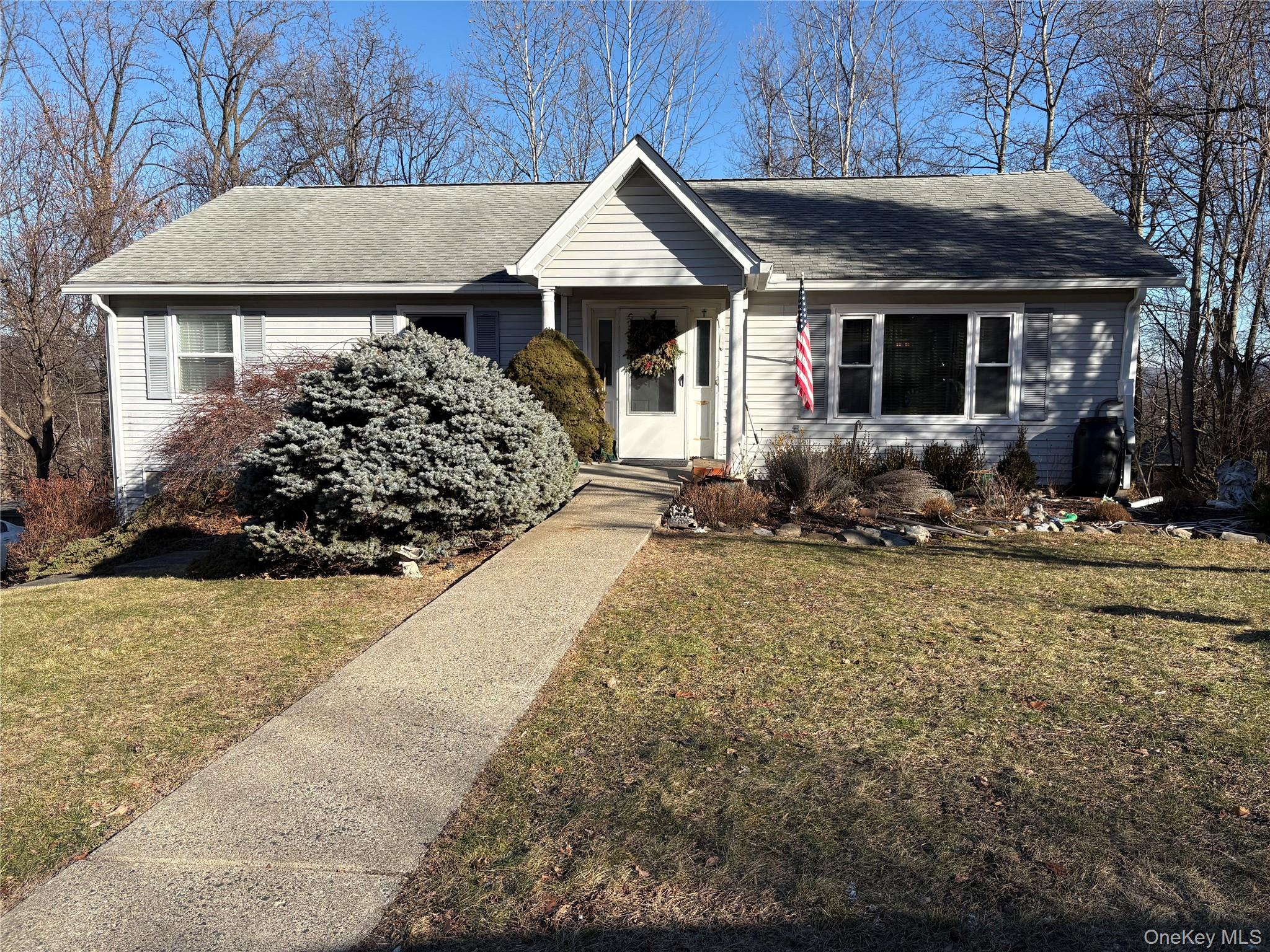 9 Rakentine Lane Garnerville, NY 10923 - Photo 1 of 2 a front view of a house with garden
