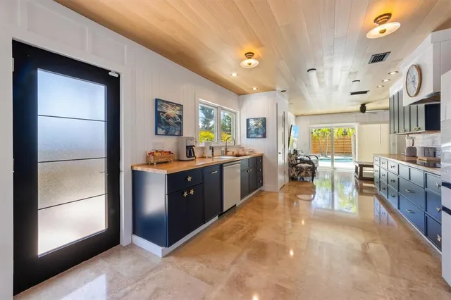 a kitchen with stainless steel appliances granite countertop a refrigerator and a sink