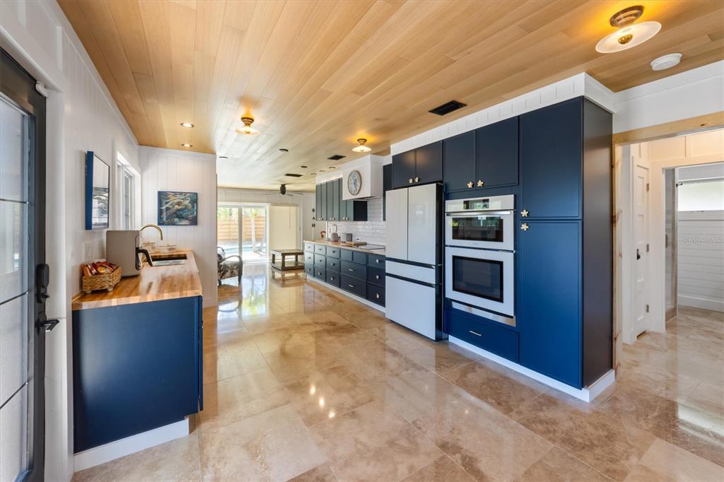 412 Alamanda Road Anna Maria, FL 34216 - Photo 12 of 43 a kitchen with stainless steel appliances kitchen island granite countertop a refrigerator and a stove