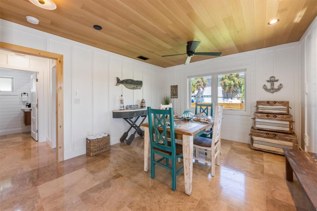 412 Alamanda Road Anna Maria, FL 34216 - Photo 17 of 43 a view of a dining room with furniture and a chandelier