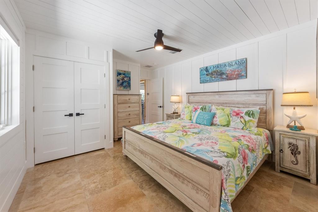 412 Alamanda Road Anna Maria, FL 34216 - Photo 22 of 43 a bedroom with a bed and a chandelier