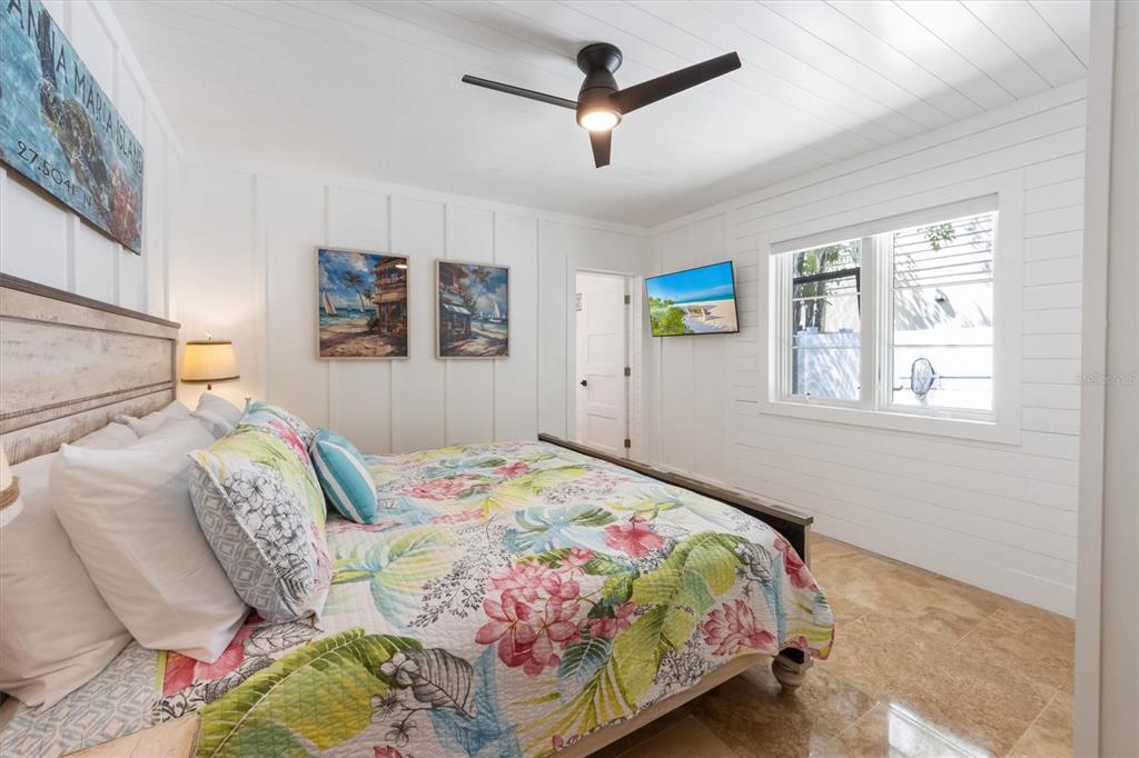 412 Alamanda Road Anna Maria, FL 34216 - Photo 23 of 43 a bedroom with a bed a dresser and a window