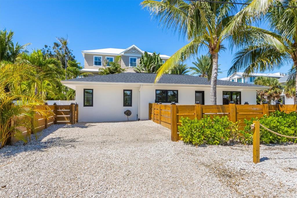 412 Alamanda Road Anna Maria, FL 34216 - Photo 3 of 43 a front view of a house with a garden