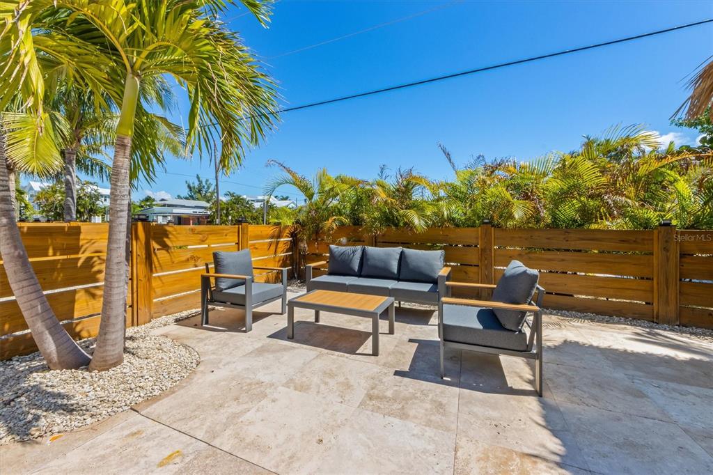 412 Alamanda Road Anna Maria, FL 34216 - Photo 32 of 43 a terrace with outdoor seating and trees
