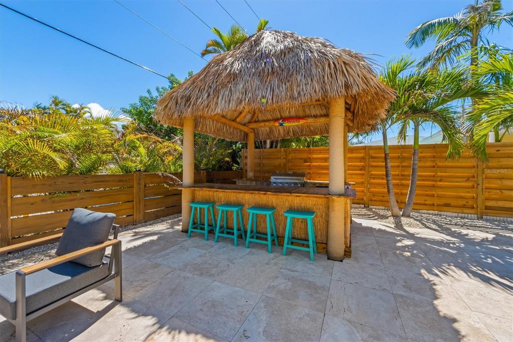 412 Alamanda Road Anna Maria, FL 34216 - Photo 33 of 43 a view of an outdoor sitting area with wooden fence
