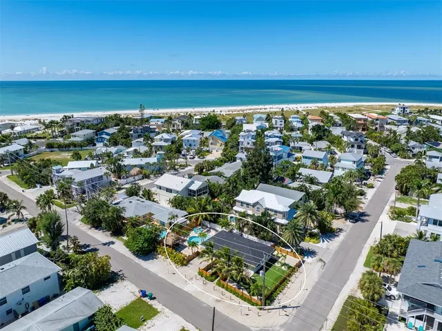 an aerial view of a city with ocean view
