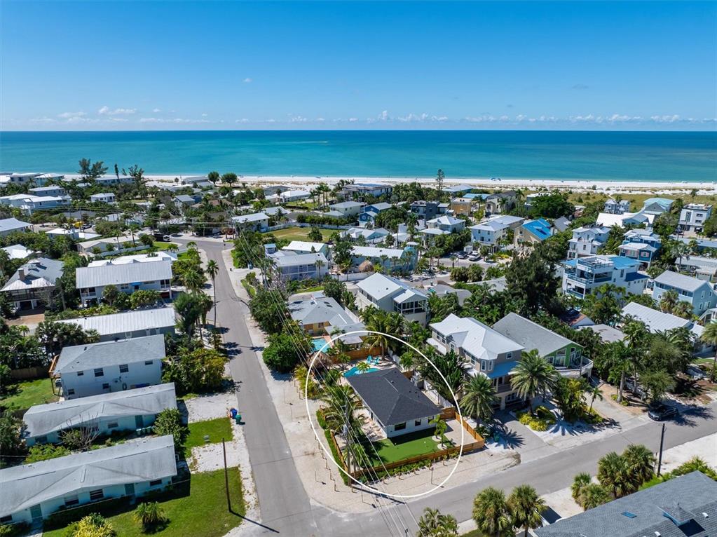 412 Alamanda Road Anna Maria, FL 34216 - Photo 40 of 43 an aerial view of a city with lots of residential buildings and ocean view in back