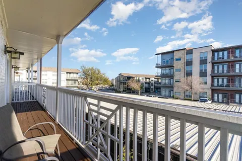 a view of a balcony with furniture